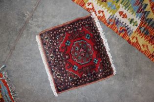 An approx. 1" x 1" Mori Jalda patterned rug