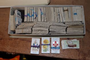 A chocolate box and contents of cigarette cards