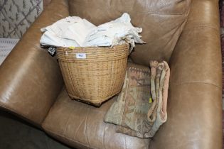A wicker basket and contents of various linen
