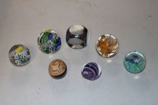 Seven various glass paperweights, some signed to b