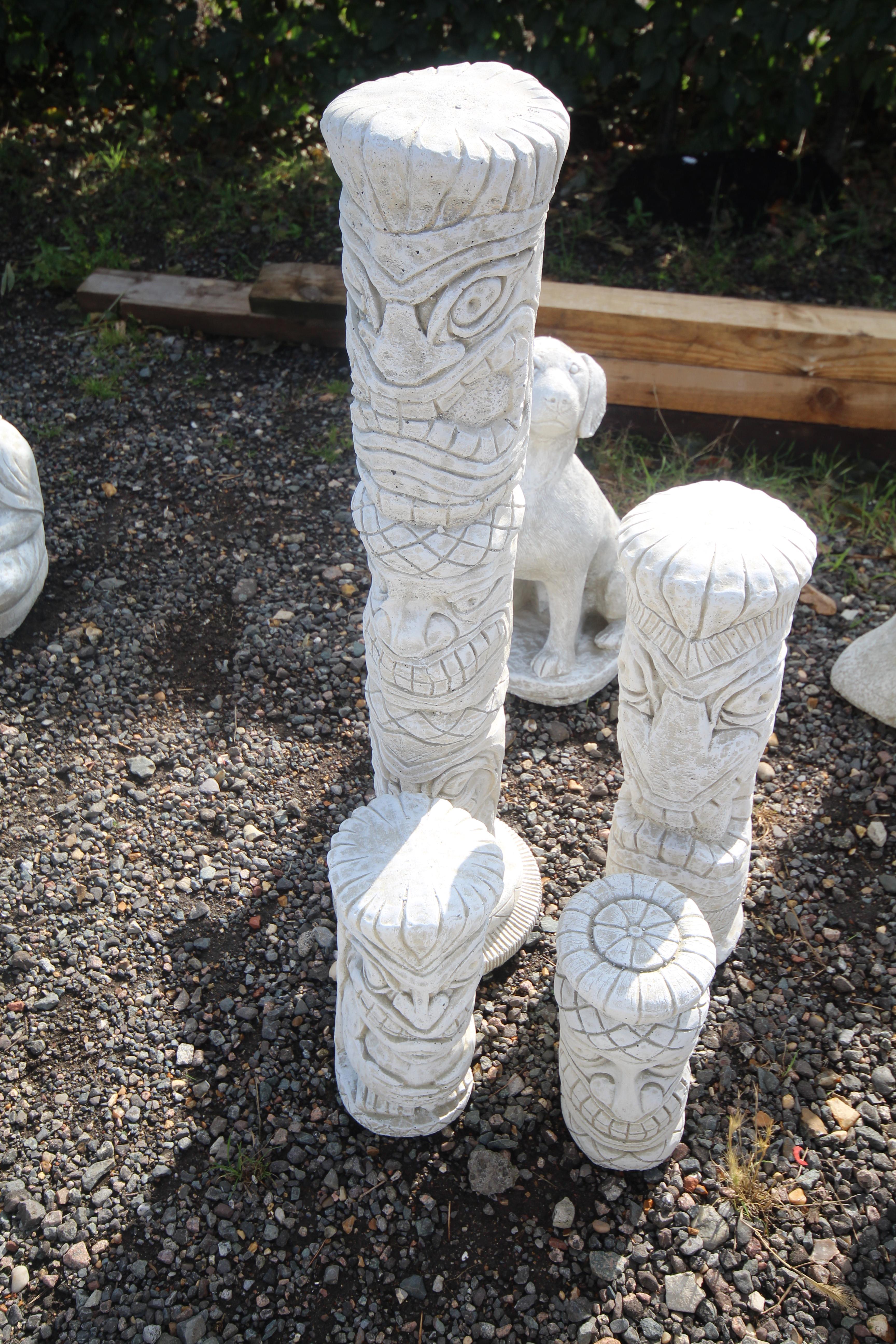 A set of four cast concrete ornaments in the form