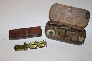 An antique wooden cased set of scales, weights marked with anchor and lion and a set of sovereign