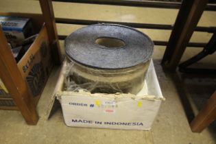 A box of various wall tiles and a roll of roofing