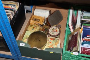A box of vintage advertising tins