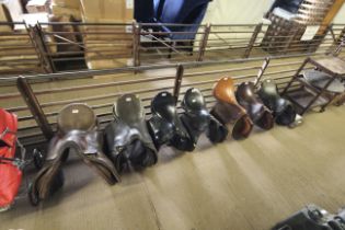 Seven various horse riding saddles