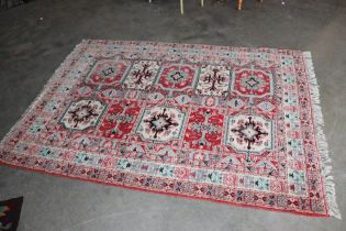 An approx. 7'8" x 5'9" patterned rug