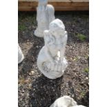 A cast concrete garden statue in the form of a mer