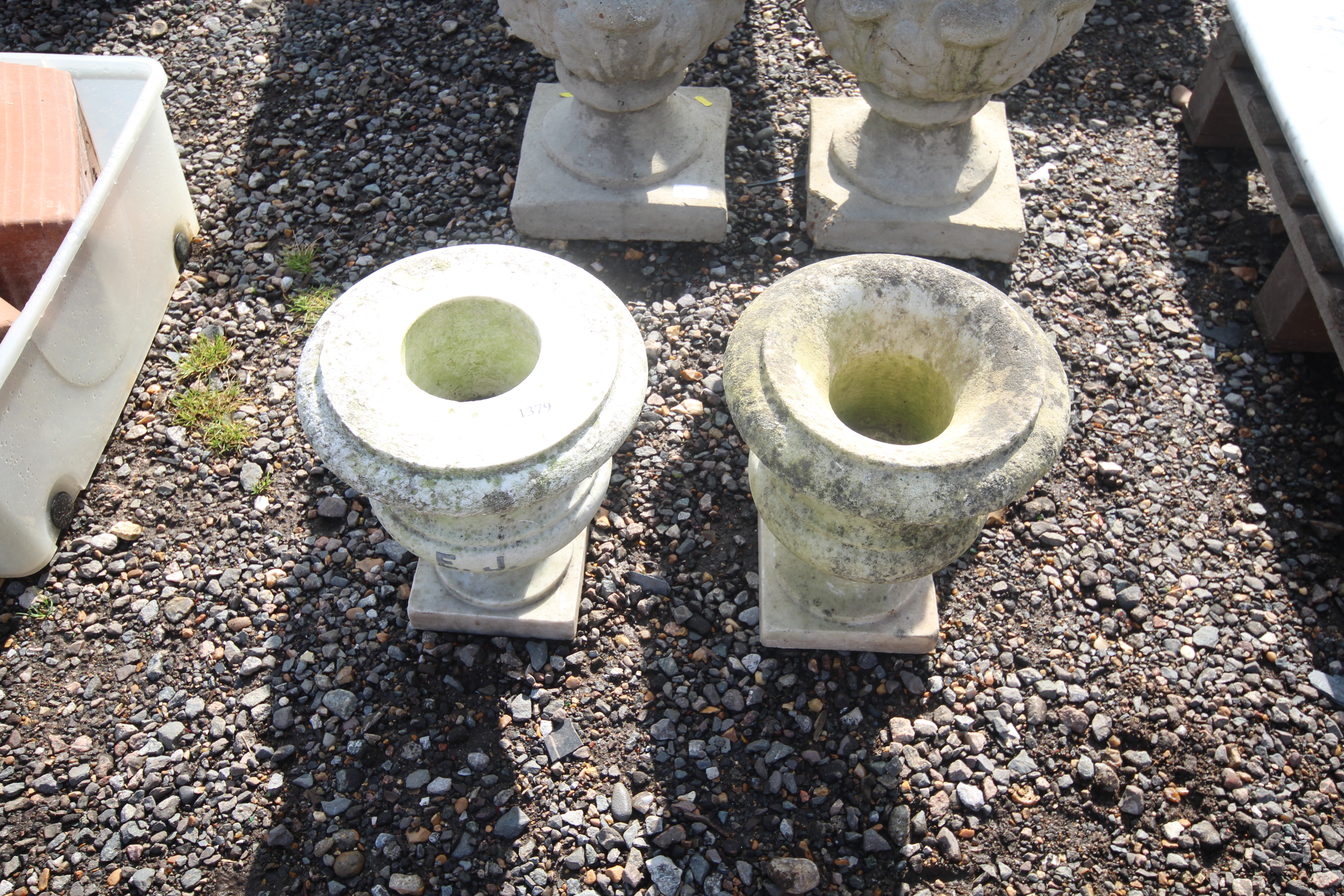 Two marble urns, one named to E. J. approx. 12" hi