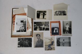 A box of vintage black and white photographs