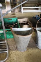 A galvanised wall mounting planter with swing hand