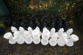 A large outdoor set of plastic chess pieces, talle