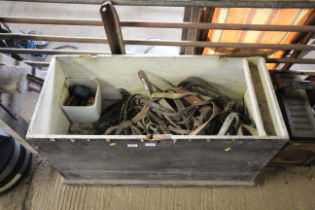 A wooden storage box and contents of various horse