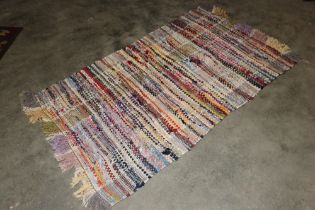 An approx. 5' x 3'1" rag rug