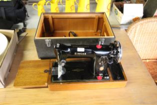 A vintage Singer electric sewing machine, sold as