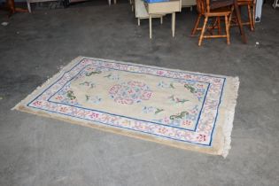 An approx. 6'2" x 4'1" floral patterned rug