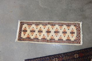 An approx. 3" x 1" Bokara rug