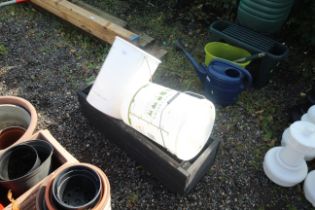 A plastic fermentation bucket with bottle lids con