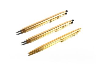 A Caran D'ache gold plated ballpoint pen; and two rolled gold ballpoint pens by Cross (3)