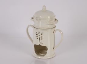 An unusual creamware heating pot, 27cm high