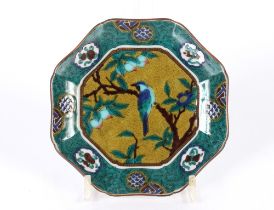 A pair of Chinese octagonal dishes decorated with birds on fruit laden branches within stylised