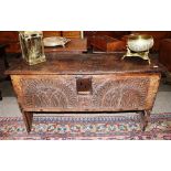 An 18th Century oak coffer, the iron hinged lid with grooved decoration above square iron lock plate