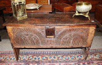 An 18th Century oak coffer, the iron hinged lid with grooved decoration above square iron lock plate