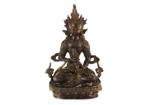 A Tibetan bronze of a seated Buddha, script to the reverse and seal mark to base, 20.5cm high