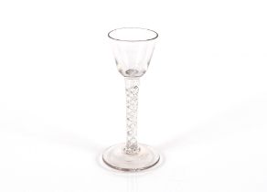 An antique drinking glass, with spiral twist column on spread foot, 13cm high