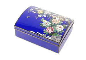 A Japanese sky blue ground cloisonné box with domed lid decorated with colourful flowers, rock