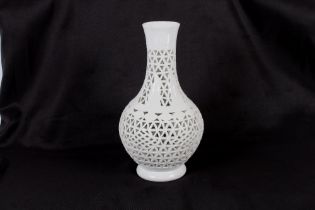 An Oriental blanc de chine reticulated vase of baluster form, 27cm