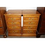 A pair of burr oak and cross banded bedside chests, fitted pull put slides and four drawers raised