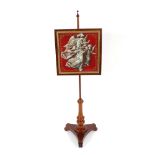 A Victorian mahogany pole screen, the beadwork embroidered banner depicting angels, raised on a