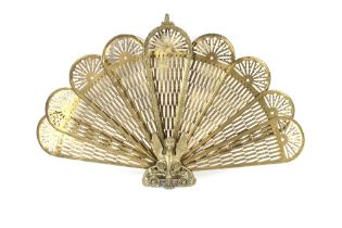 A brass peacock fireguard