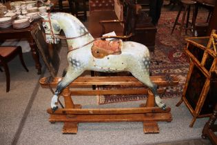 A Victorian Dapple Grey rocking horse, on pine stand, 120cm long overall x 116cm high