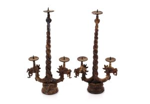 A pair of Eastern bronze pricket candlesticks with dragon decoration, 31cm high