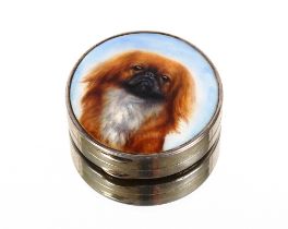 A silver and enamel circular compact by Adie Bros., the lid decorated with a Pekinese dog