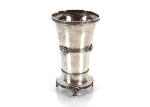 An unusual continental silver flaring beaker decorated with strapwork and bosses raised on three