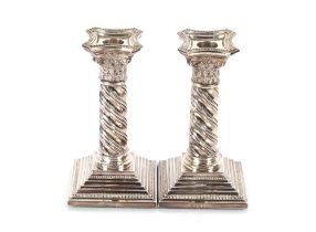 A pair of late 20th Century silver dwarf candlesticks, having beaded borders, classical capitals and