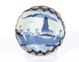A Chinese blue and white shallow dish decorated with a river scene, 14.5cm dia.