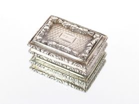 A Victorian silver vinaigrette, the cast lid with foliate borders and engine turned base, indistinct