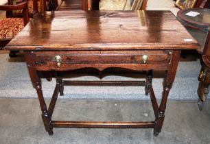 A 18th Century oak side table fitted with a single drawer, having brass acorn drop handles (one AF),