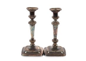 A pair of 19th Century plated candlesticks with gadroon and floral decoration, 27cm high