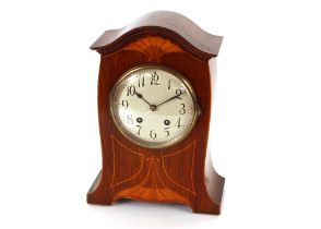 An Edwardian Art Nouveau design inlaid mantel clock having eight day movement striking on a gong,