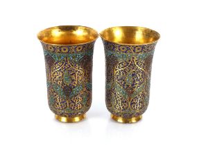 A pair of Indo-Persian gilt copper and enamel beakers, 19th Century, decorated with foliate