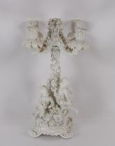 A Meissen Marcolini period blanc de chine four branch candelabra with cherub and vine decoration,