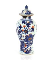 A  19th Century Chinese blue and white baluster vase, decorated figures in an exotic garden setting,