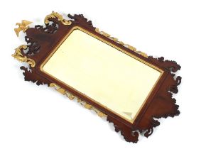 A mahogany and gilt wood Chippendale style wall mirror, with bevelled plate surmounted by and