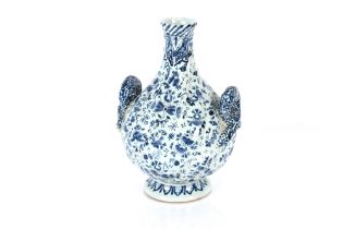 A 20th Century Delftware blue and white baluster vase, flanked by serpent handles having profuse