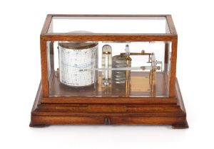 A barograph by Negretti & Zambra of London, in oak case with bevel glass panels and chart drawer,