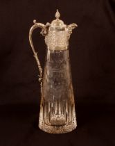 A heavy 20th Century cut crystal and silver mounted claret jug, the mounts profusely decorated